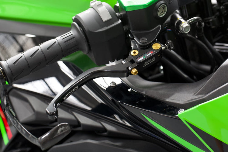 MOTO-TRON EVO-R folding brake lever installed on a green Kawasaki sportbike